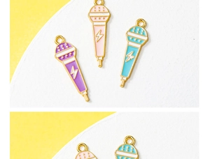 Detail showing colorful microphone charms in purple, pink, and blue with gold trim