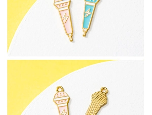 Detailed view of pink and blue enamel microphone pendants with gold lightning bolt patterns