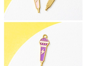 Macro detail of purple microphone charm with gold plating and lightning bolt for DIY jewelry