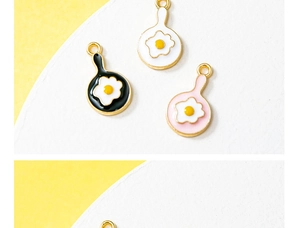 Detail of colorful alloy frying egg pendants for DIY jewelry and keychain making
