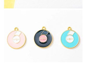 Close-up of DIY alloy colorful enamel record pendants with WOW lettering in a set of three