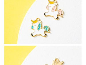 Detailed view of colorful unicorn enamel charms in pink and blue for DIY jewelry making