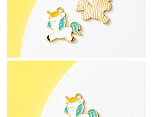 Detailed view of colorful unicorn enamel charms for DIY jewelry with metal back texture