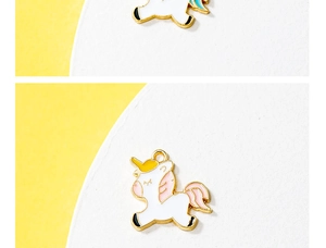 Detailed macro view of a white and pink enamel unicorn charm with gold-plated finish