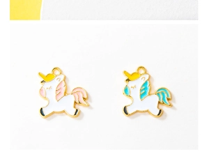 Close-up of colorful unicorn enamel pendants with metal edges for DIY jewelry making