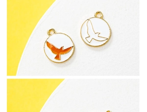 Macro view of golden eagle pendant charms with white enamel inlay for DIY necklaces