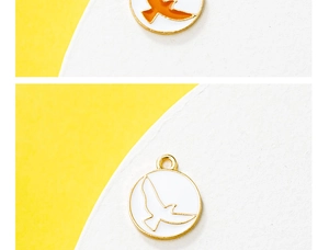 Detail of round alloy bird charm with enamel finish for DIY jewelry and necklaces