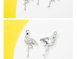 Macro view of rhinestone flamingo pendants and engraved metal charms for jewelry