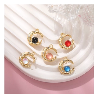 Detail of moon-shaped alloy pendants with aurora rhinestones in five various colors