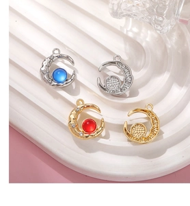 Detailed view of aurora glass moon pendants with colorful beads for DIY jewelry making