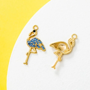 Golden flamingo pendants with blue rhinestones and radiant texture for jewelry making