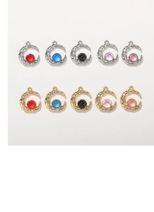 Detailed view of moon-shaped charms with lava texture and colorful aurora glass rhinestones