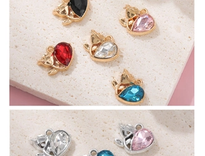 Detail of colorful fox-shaped alloy pendants with water-drop crystal inlays and metal rings