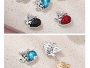 Detail view of heart-shaped crystal charms with metallic flower accents and textured back