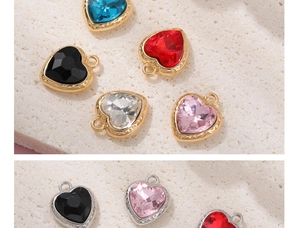 Macro shot of colorful heart-shaped crystal pendants with metal base and hanging loops