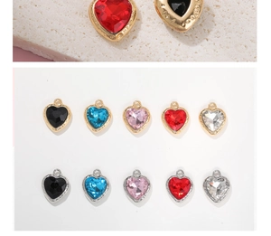 Macro shot of faceted heart-shaped crystal pendants with gold and silver alloy frames