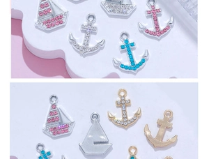 Detail of 14K gold plated nautical starfish and sailboat charms with pink rhinestones