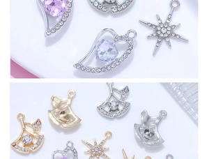 Macro detail of heart and star pendants with pave crystals and purple pear-shaped gems