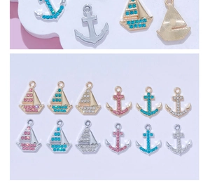 Detailed view of 14K gold-filled nautical charms with colorful pavé rhinestones