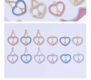 Close-up of Eiffel Tower heart pendants with colorful zircon inlay in various colors
