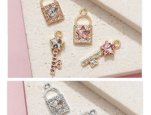 Macro detail of star-shaped key and lock pendants with pink and white rhinestones
