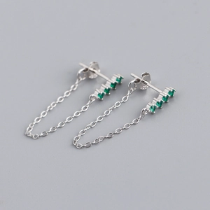 Close-up of S925 sterling silver earrings with green zircon stones and hanging chain link