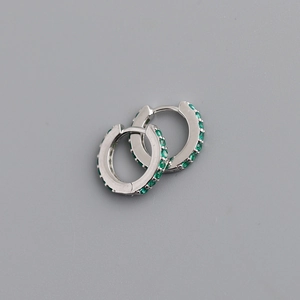 Detailed close-up of S925 sterling silver huggie earrings with green zircon micro-paving