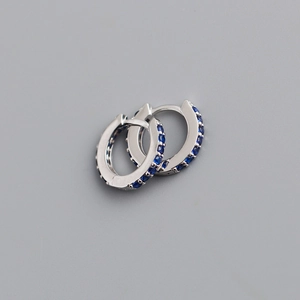 Detail of 7mm S925 sterling silver huggie earrings with micro-paved blue cubic zirconia