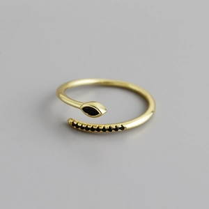 Macro shot of gold adjustable ring with marquise black stone and pavé black zircons