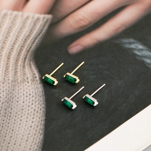 Detail of square green zircon earrings in gold and silver plating on s925 silver