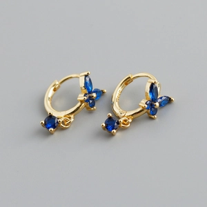 Macro view of gold S925 silver hoop earrings with marquise blue stones and S925 hallmark