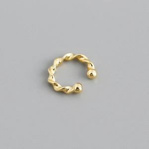 Close-up of twisted rope gold ear cuff with polished finish and spherical ends