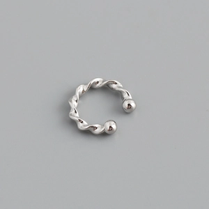 Detail of s925 silver ear cuff with spiral twisted design and polished ball ends
