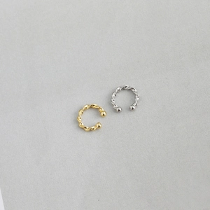 Detail of twisted s925 silver ear cuffs in gold and silver finish for non-pierced ears