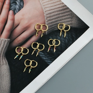 Detail of S925 sterling silver gold plated hoop earrings with colorful zircon dagger charms