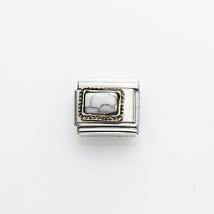 Detailed macro of Italian charm link with white turquoise and gold vintage border