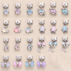 Detail view of colorful heart, moon, and star Italian charm bracelet links in stainless steel