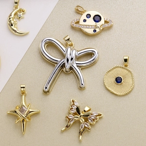 Celestial gold-plated charms set featuring moon, star, evil eye, and butterfly designs