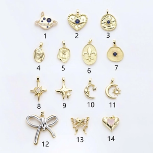 Selection of 14 vintage gold-plated star moon and evil eye charms for DIY jewelry making