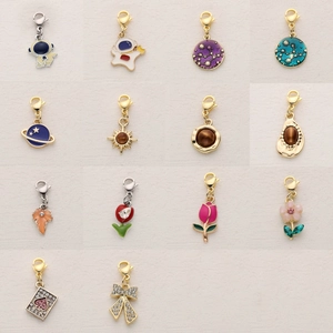 Assorted alloy charms with lobster clasps featuring astronaut planet and floral designs