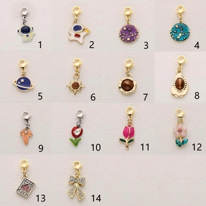 Set of 14 assorted alloy charms with lobster clasps featuring planet and astronaut themes