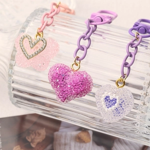 Sparkling candy heart keychains in pink, magenta, and purple with matte finish hardware