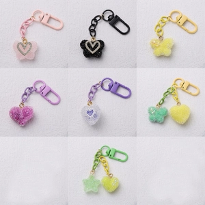 Colorful resin heart and star keychain pendants with glitter finish in multiple colors