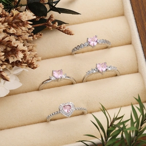 Adjustable silver ring set with pink heart zirconia and pavé stones on velvet display