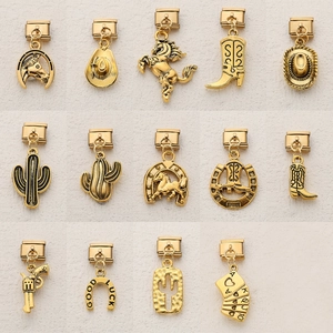 Detail view of 14 gold vintage cowboy charms including boots and hats for DIY bracelets