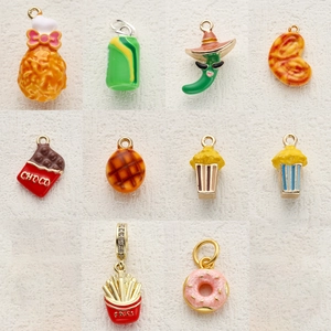 Detailed flat lay of food-themed enamel alloy pendants including fries and donuts