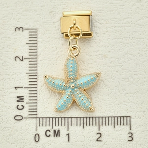 Italian charm bracelet pendant with starfish design in gold finish and light blue enamel