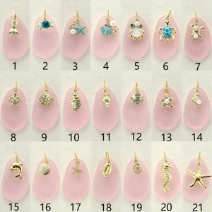 Collection of 21 gold alloy ocean themed pendants with colorful enamel and pearls