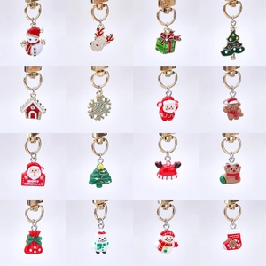 Macro view of Christmas enamel charms featuring Santa Claus, reindeer, and snowflakes