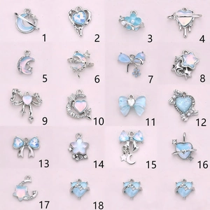 DIY jewelry charm set with light blue heart, moon and star designs on silver metal base